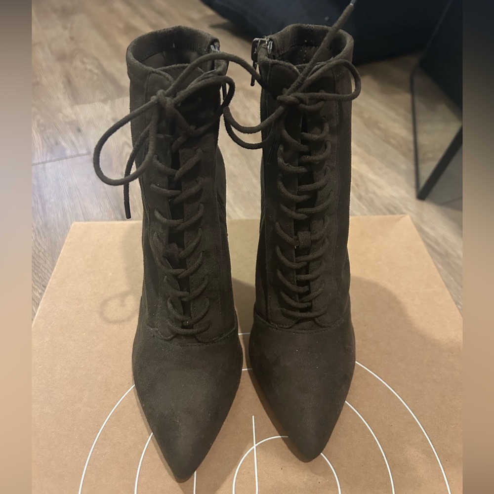 Olive green front lace up boots with a zipper closure on the inside.